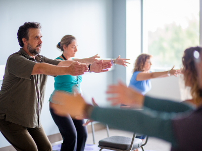 action shot of four participants in a yoga class